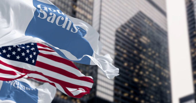 Goldman Sachs bank and the United States flags waving in a financial district