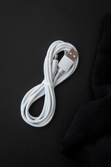 Unoriginal, fake USB-A and Lightning cable, white color on dark background - obrazy, fototapety, plakaty