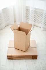 Medium sized empty cardboard boxes on a light colored background