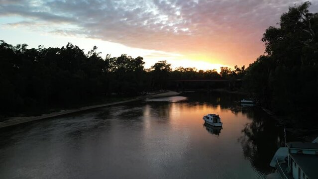 Travel along Murray River at sunset - paddle-boarder, boats - Victoria Australia