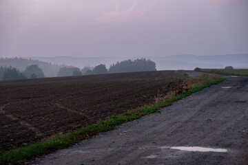 misty sunset, plowed field, sunset with red clouds, path between fields