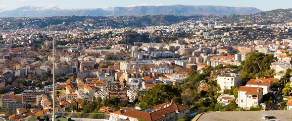 Panoramic view of Nice residential districts against backdrop of Alps in sunny day, France - obrazy, fototapety, plakaty