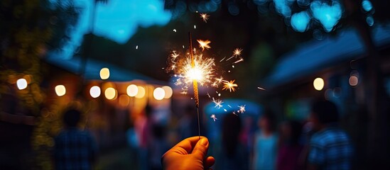 Blue hour backyard family celebration with sparkler hand