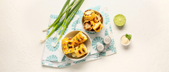 Composition with tasty grilled corn cobs on white background, top view