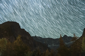 Star Trails over Mountains of Mont Blanc Massif. Switzerland. Starry Sky. Night Landscape