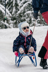 Little girl playing in a deep snow