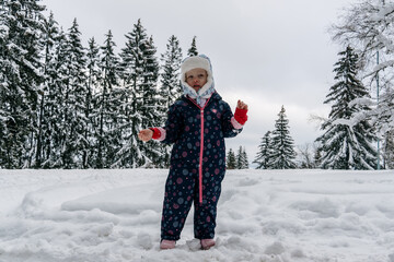 Little girl playing in a deep snow