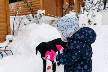 Little girl playing in a deep snow