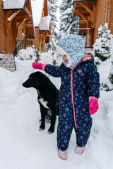 Little girl playing in a deep snow