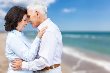 Obraz premium Senior happy couple have fun on the beach