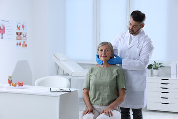 Endocrinologist examining thyroid gland of patient at hospital. Space for text