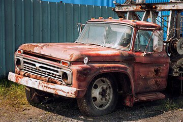 Vintage rusty towing truck abandoned in a scrap yard. Sunny summer day. - 666837608
