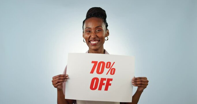 Face of business owner, sale poster or black woman in studio on blue background for 70 percent off. Advertising promotion, happy or waitress pointing to sign on paper for cafe discount marketing