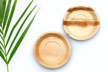 Betel palm leaf plates on white background.