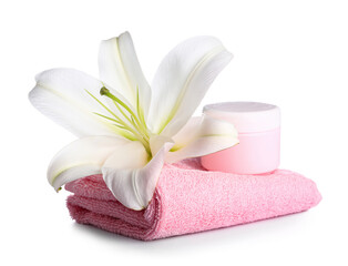Obraz na płótnie Canvas Clean towel, jar of cosmetic product and beautiful lily flower on white background