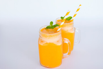 Orange smoothies yellow colorful fruit juice milkshake blend beverage healthy high protein the taste yummy In glass,drink to lose weight drink episode morning isolated on white background.