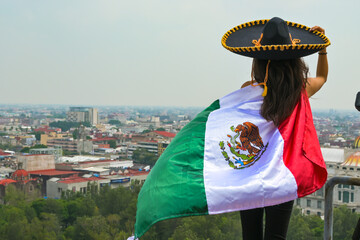 Woman with flag of Mexico, celebrating Mexican Independence Day.September 16. Mexican Independence Day.