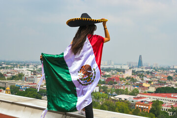 Woman with flag of Mexico, celebrating Mexican Independence Day.September 16. Mexican Independence Day.
