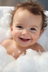 Cute baby in bathtub with foam