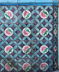 Rows of antique Nyonya Tiles with pink flowers with green background. Vintage Baba and Nyonya style floral tile pattern in penang. Traditional Peranakan cultural in Malaysia.