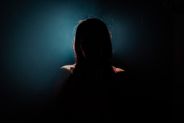 unrecognizable woman silhouette on black background