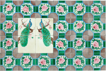Rows of antique Nyonya Tiles with pink flowers and peacocks. Vintage wall tile in penang.