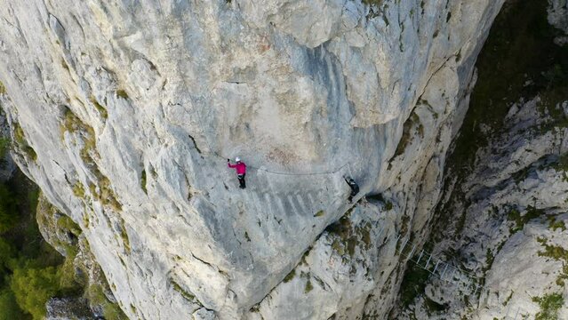 Two Female climbers mountaineering, via ferrata in "Red Rocks", Mountain Romanija in Bosnia and Herzegovina