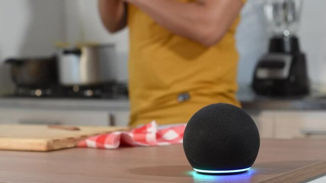 Voice assistant Amazon Alexa Echo Dot 5 generation in house, man while cooking, washing hands, help in the kitchen	