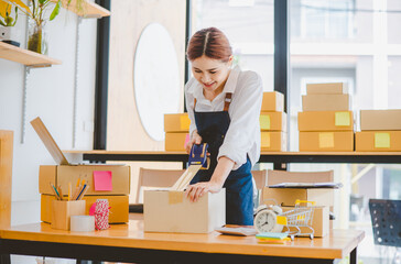 Online small business owners are packing their ordered products into the boxes for their customers based on the concept of online shopping - online shopping.