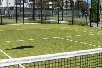 synthetic court in a park in summer, tennis court with a net