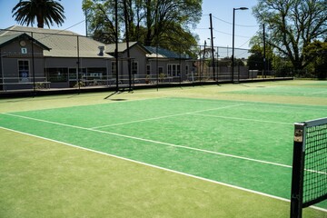 synthetic court in a park in summer, tennis court with a net