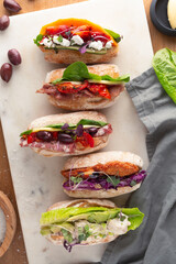 Healthy sandwich rolls rest on a table top.