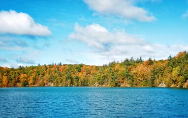 Pink Lake, Gatineau, Quebec, Canada during fall season with colorful tree