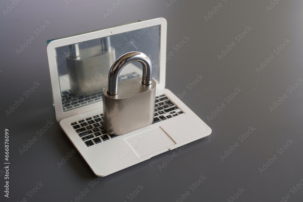 Sticker closeup image of laptop and padlock with copy space. cyber security concept.