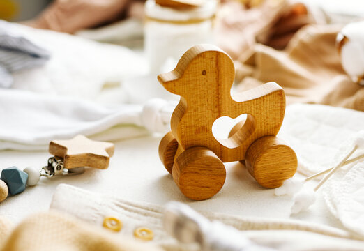 A small wooden duck on wheels, children's toys. Selective focus.