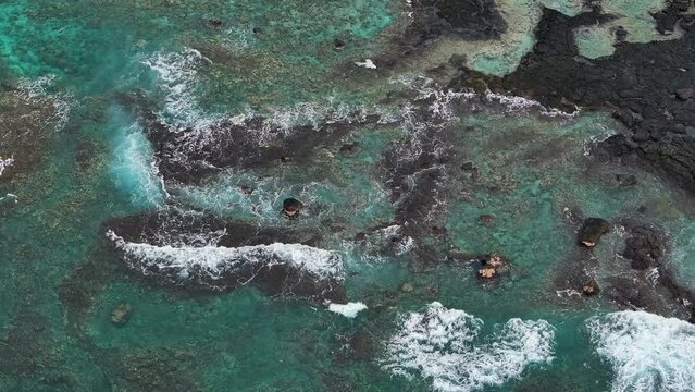 Aerial beautiful blue green ocean Honaunau Bay Kona Hawaii. Beautiful cove bay with blue Pacific ocean water. Vacation destination. Black volcanic lava rock. Tropical landscape, tourist destination.