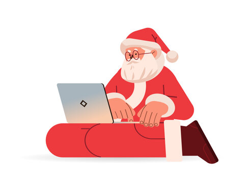 santa claus in red costume typing on laptop happy new year merry christmas holidays celebration concept isolated