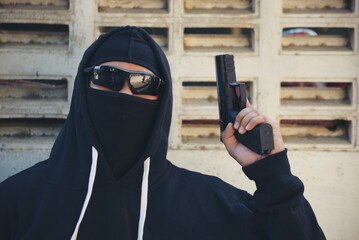 Terrorist war criminal men holding gun weapon in hand mafia attack make a crime thief in black...