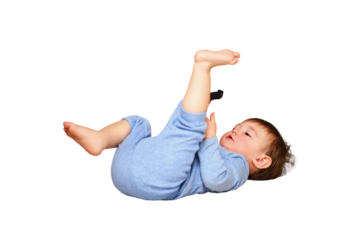 Toddler baby plays on the cold stone tile floor, isolated on a white background. A child with a toy car lies on a cold home floor, isolated on a white background. Kid aged one year and three months