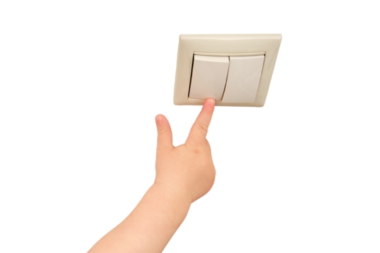 Toddler baby reaches for the light switch, child's hand turns on the lamp close-up, isolated on a white background. White light switch in home room and baby hand