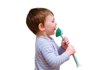 Happy toddler baby with a cleaning brush in the house, isolated on white background. A funny child is holding a large brush in his hands.