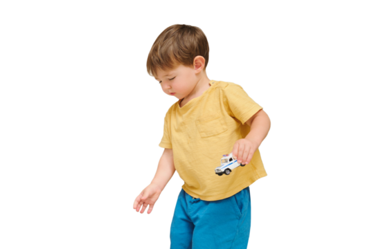 Baby is happily picking up and collecting his toys for cleaning, isolated on white background. Kid toddler boy aged two years
