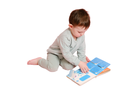 Happy toddler baby is reading a book on studio, isolated on white background. Child boy plays with a book, isolated on white background. Kid age one year eight months, full height