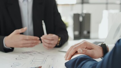 Cropped shot of two unrecognizable business partners discussing project and actively gesticulating during office meeting