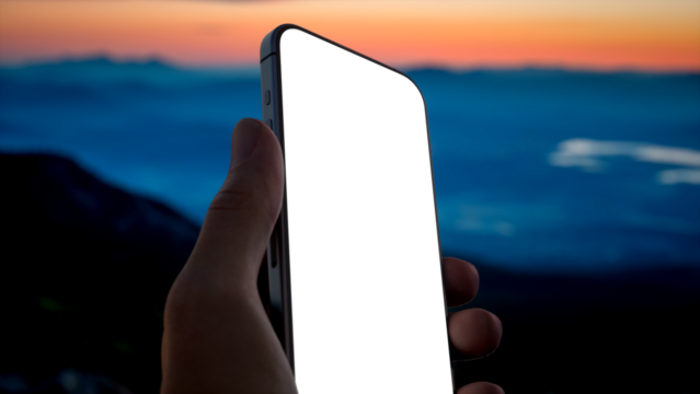 Caucasian male using his phone on a mountain peak at dawn