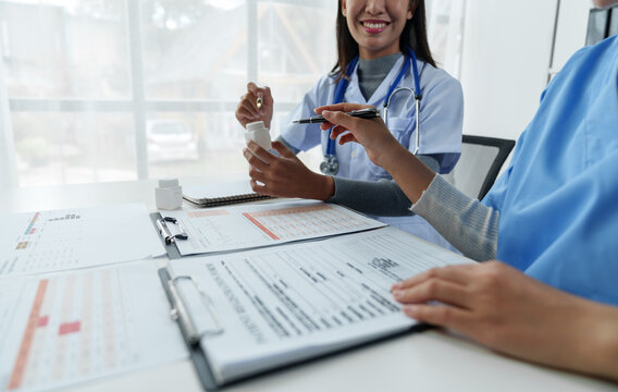 Doctors follow up on treatment, consult patients, and perform diagnostic work while writing prescription information sheets in clinics or hospital offices. medical and health concepts.