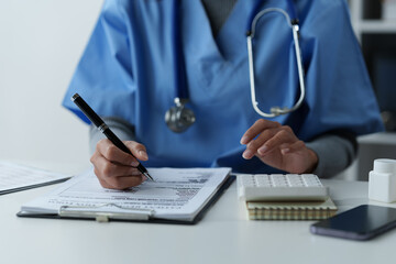 Asian female patient talking with doctor in hospital Screening doctors and writing patient information in charts Historical data health promotion Concept of maintaining physical health and medicine.