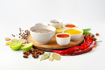 Bowls with spices on wooden board on white background