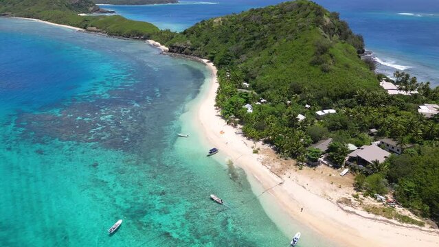 Shallow turquoise water around tropical island in Fiji Yasawas