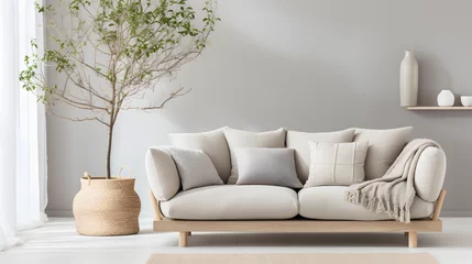 Fototapeten Wicker pot with blossom tree near beige sofa with many pillows and plaid. Scandinavian interior design of modern stylish living room © Samira